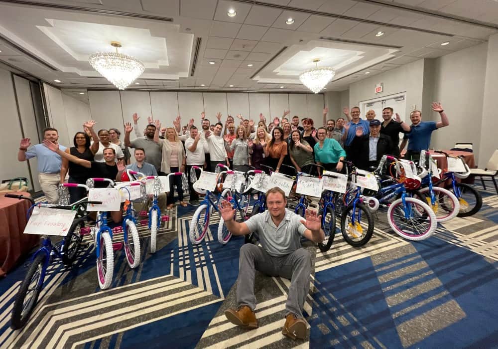 A company group in a hotel meeting room after a Bike Build Donation
