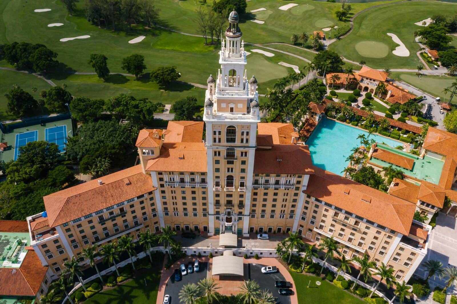 The Biltmore Hotel's tower and red-tile roofs above the golf course in Coral Gables, FL, seen from the air