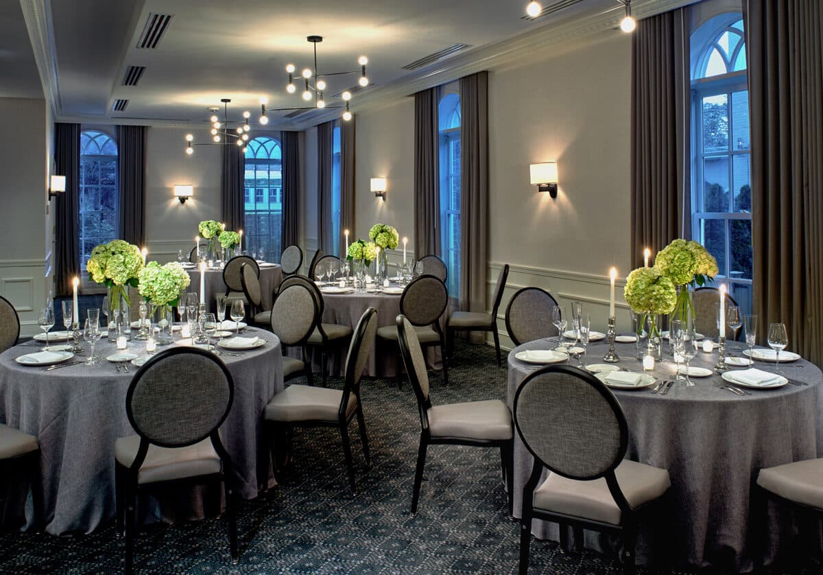 The Watermark Ballroom at Morrison House set for dinner with hydrangea centerpieces and candlelight, Old Town Alexandria, VA