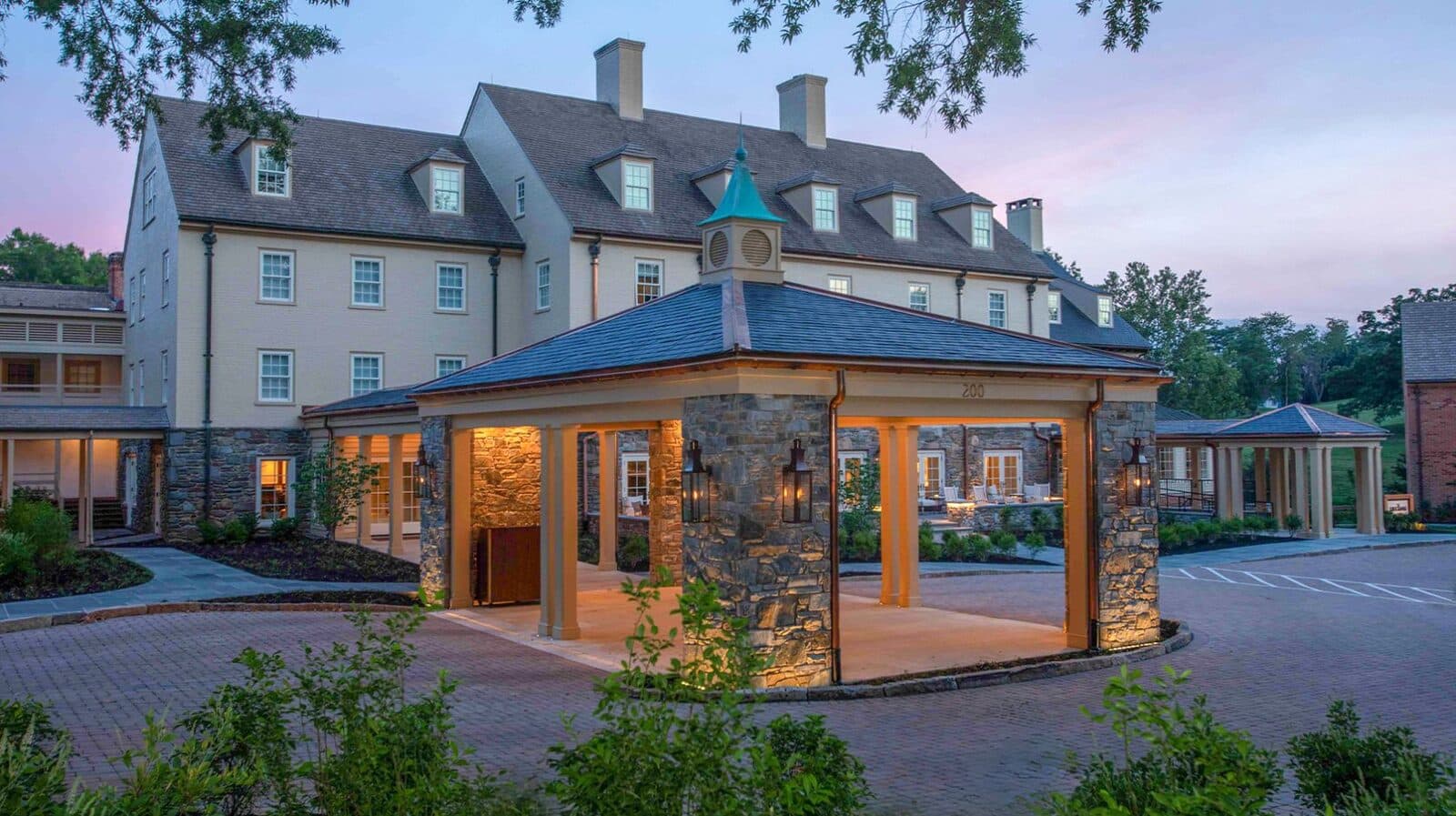 The Boar's Head Resort inn and lit stone pavilion at dusk, Charlottesville, VA