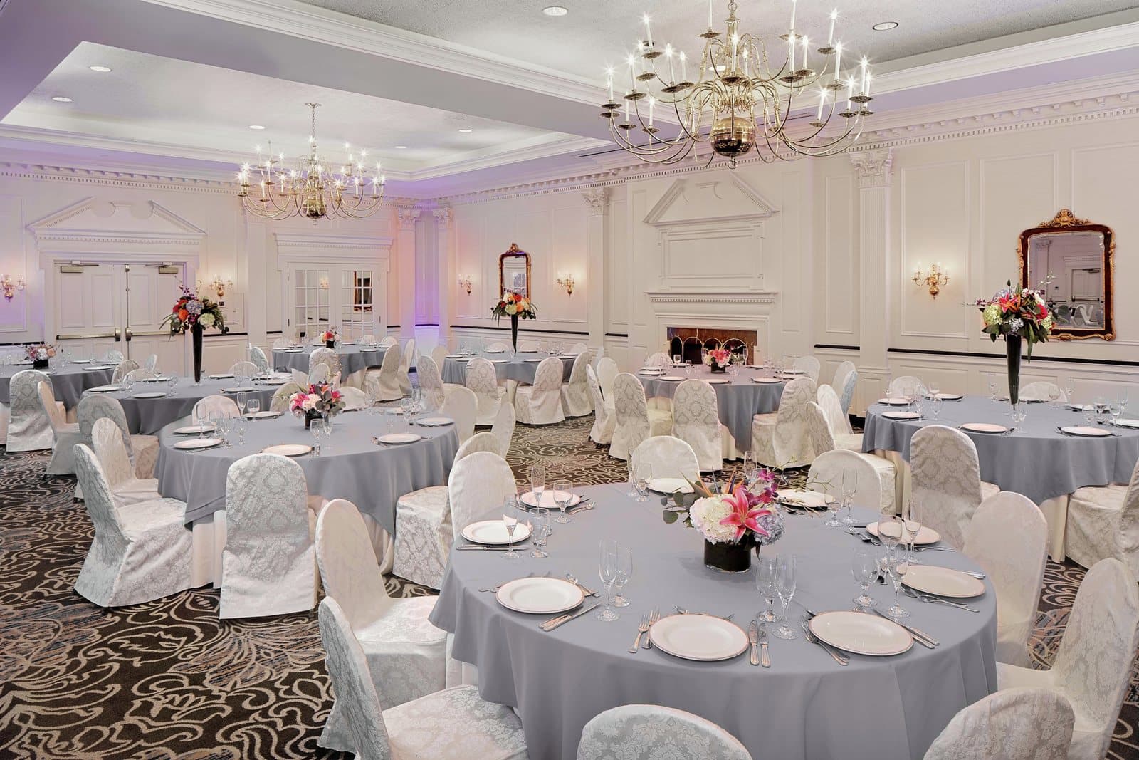 The Desmond Ballroom set with round tables under brass chandeliers, Malvern, PA