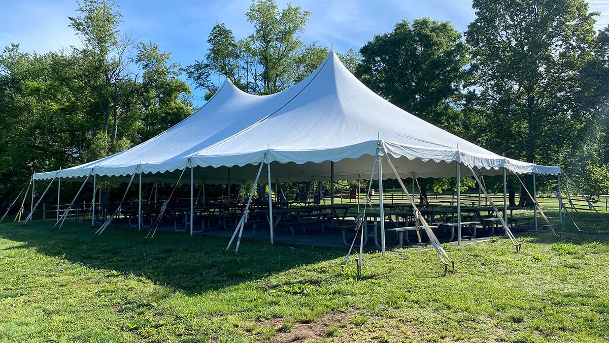 A large white event tent on the lawn among summer trees at Lake Fairfax Park, Reston, VA
