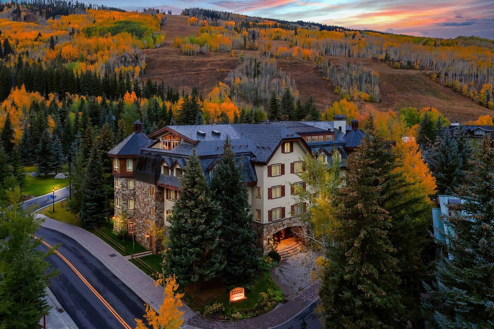 Tivoli Lodge among evergreens and fall aspens at the foot of Vail Mountain