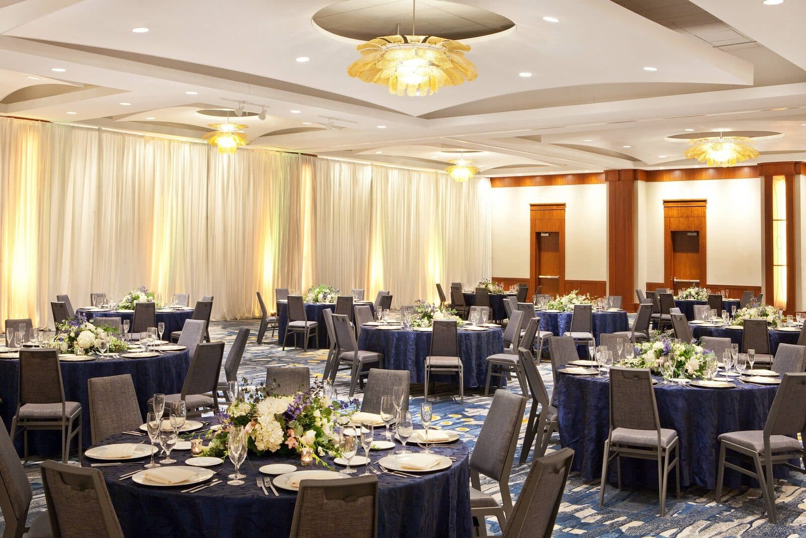 The Westin Alexandria Old Town ballroom set with round banquet tables under chandeliers, Alexandria, VA