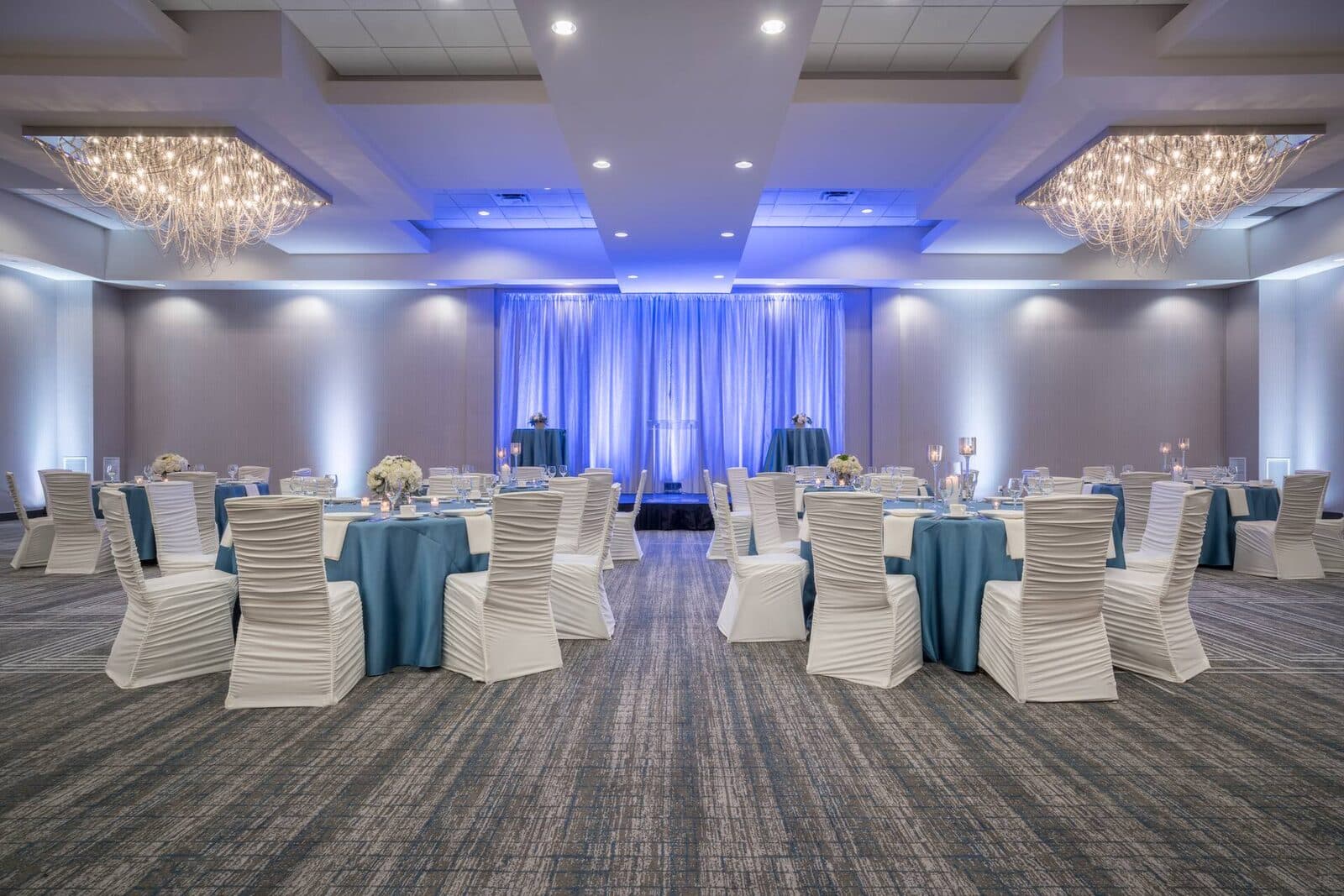 The ballroom at Hilton Minneapolis/Bloomington set for a gala with round tables under crystal chandeliers, Bloomington, MN