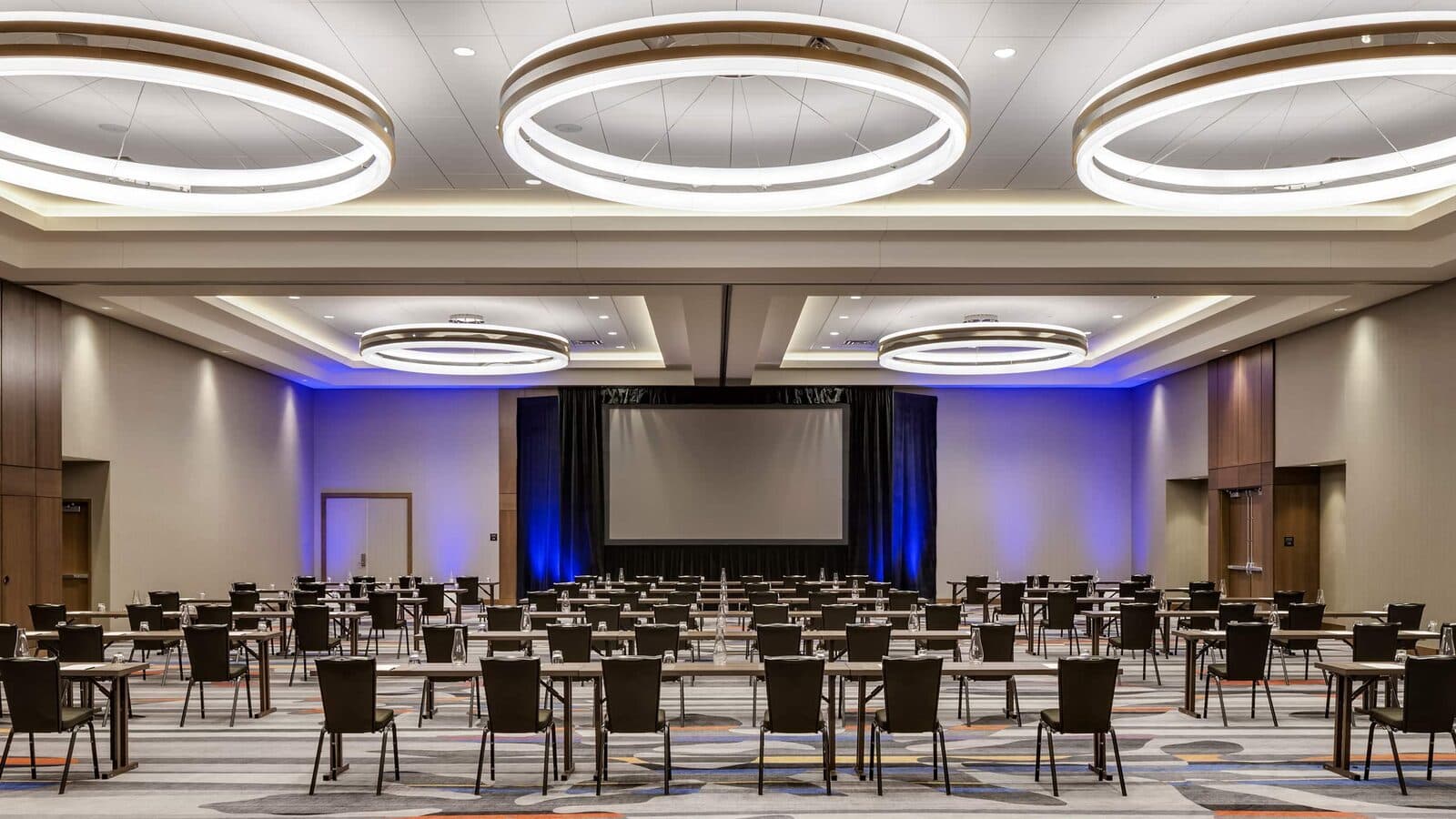 The Grand Central Station Ballroom at Hyatt Regency Bloomington Minneapolis set with tables facing a screen and stage, Bloomington, MN