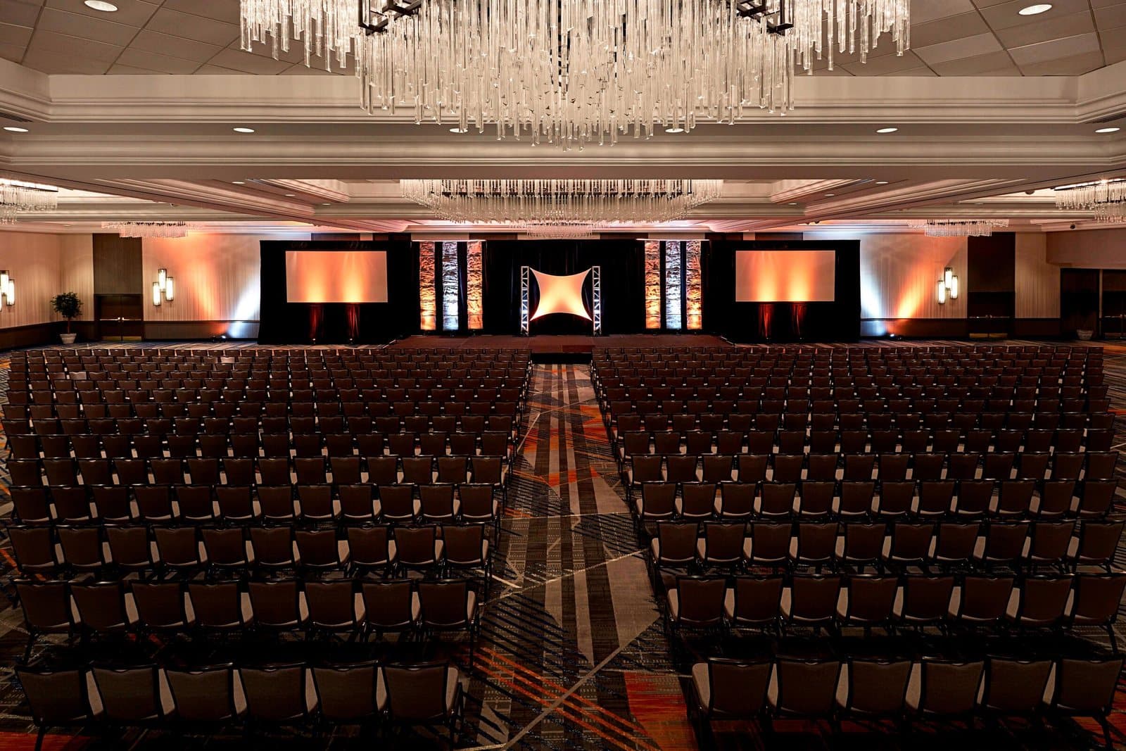 The ballroom at the New York Marriott at the Brooklyn Bridge set theater style under crystal chandeliers
