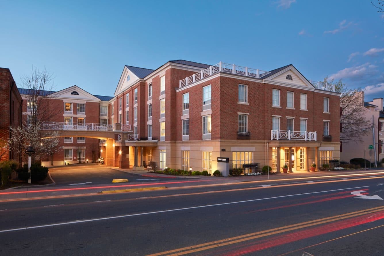The Courtyard Charlottesville University Medical Center's brick facade on West Main Street at dusk, Charlottesville, VA