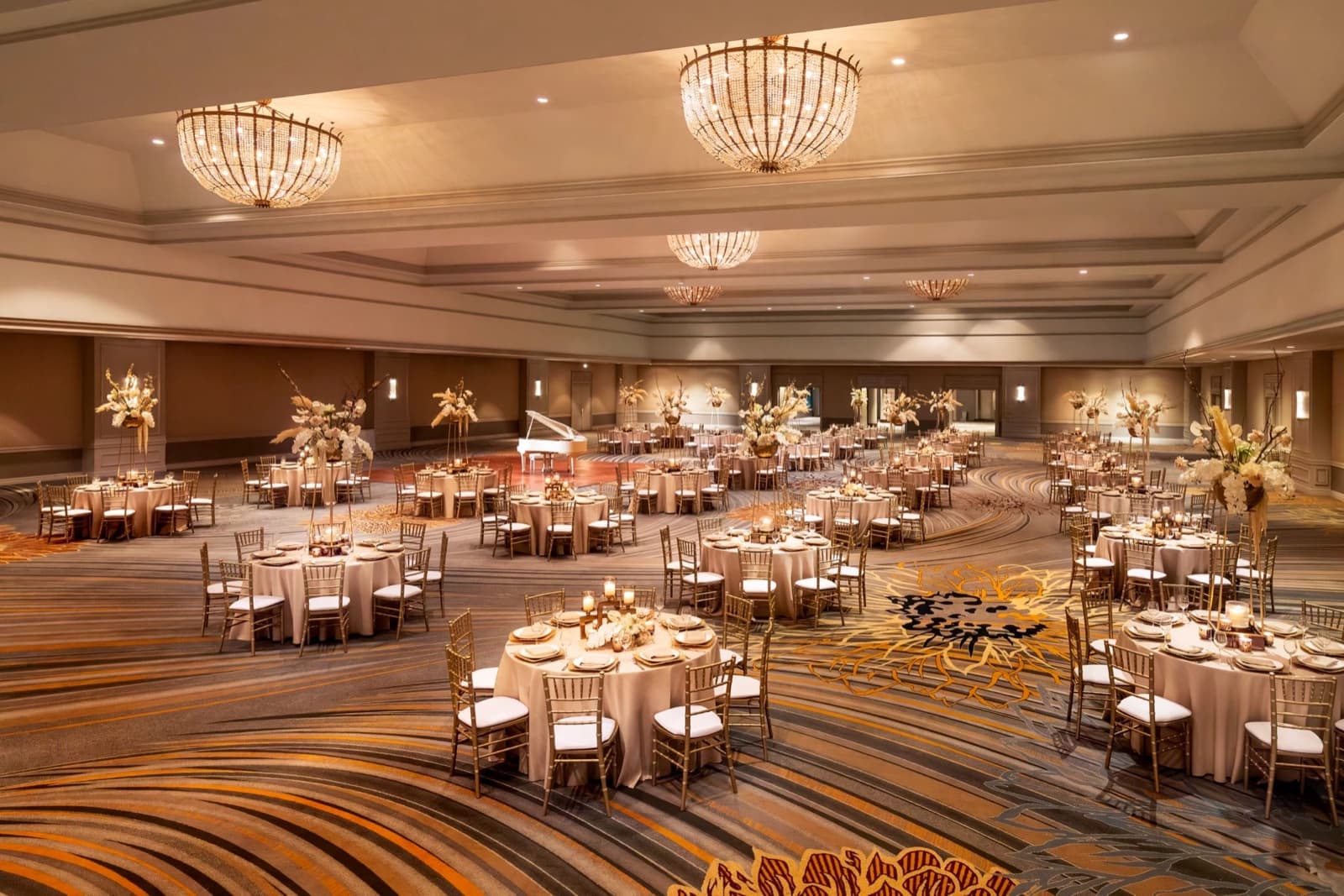 A Fairmont Chicago Millennium Park ballroom set with banquet rounds under crystal chandeliers