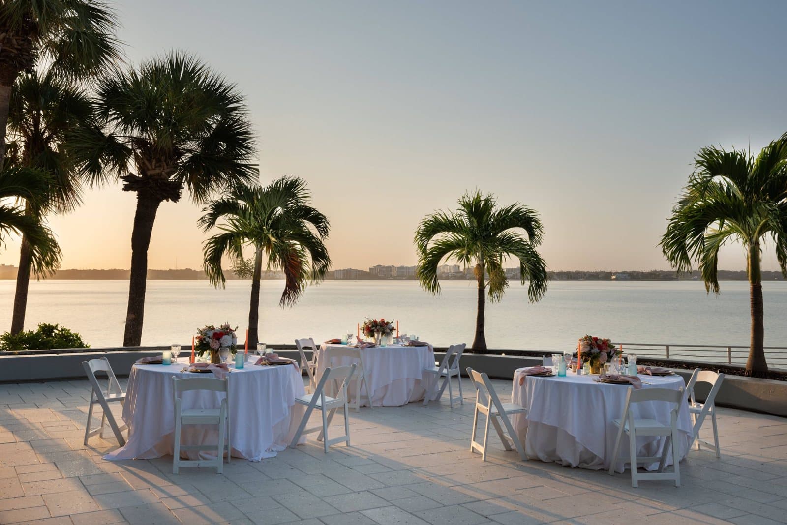 Waterfront terrace set with dinner rounds at sunset at Clearwater Beach Marriott Resort on Sand Key, Clearwater Beach, FL