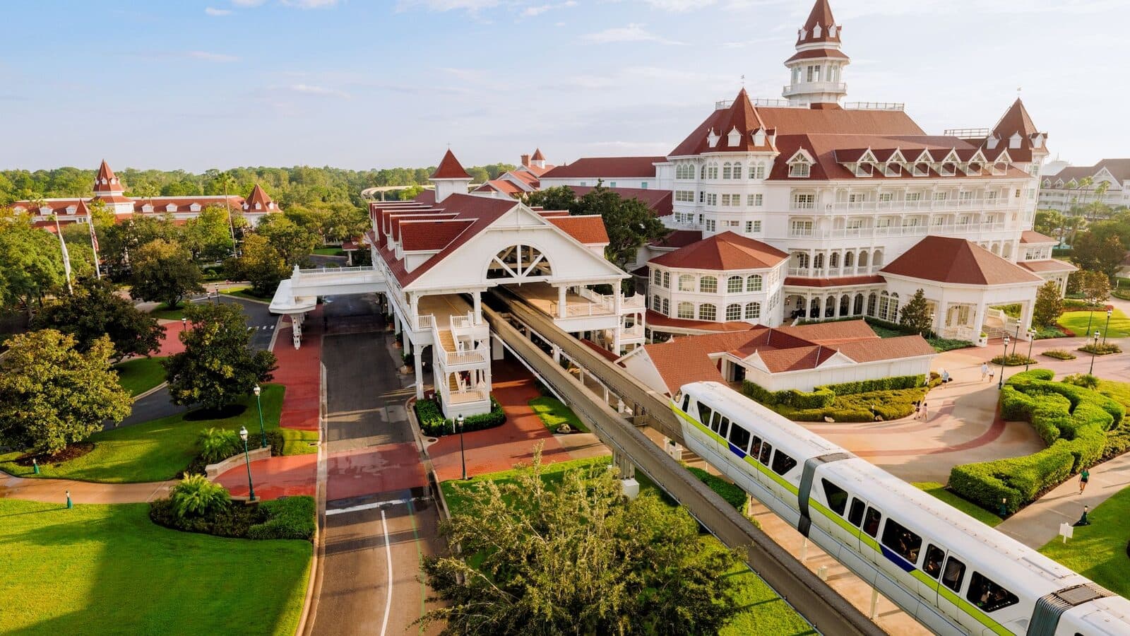 The Grand Floridian's white Victorian buildings and red roofs, with the monorail passing in front, Walt Disney World