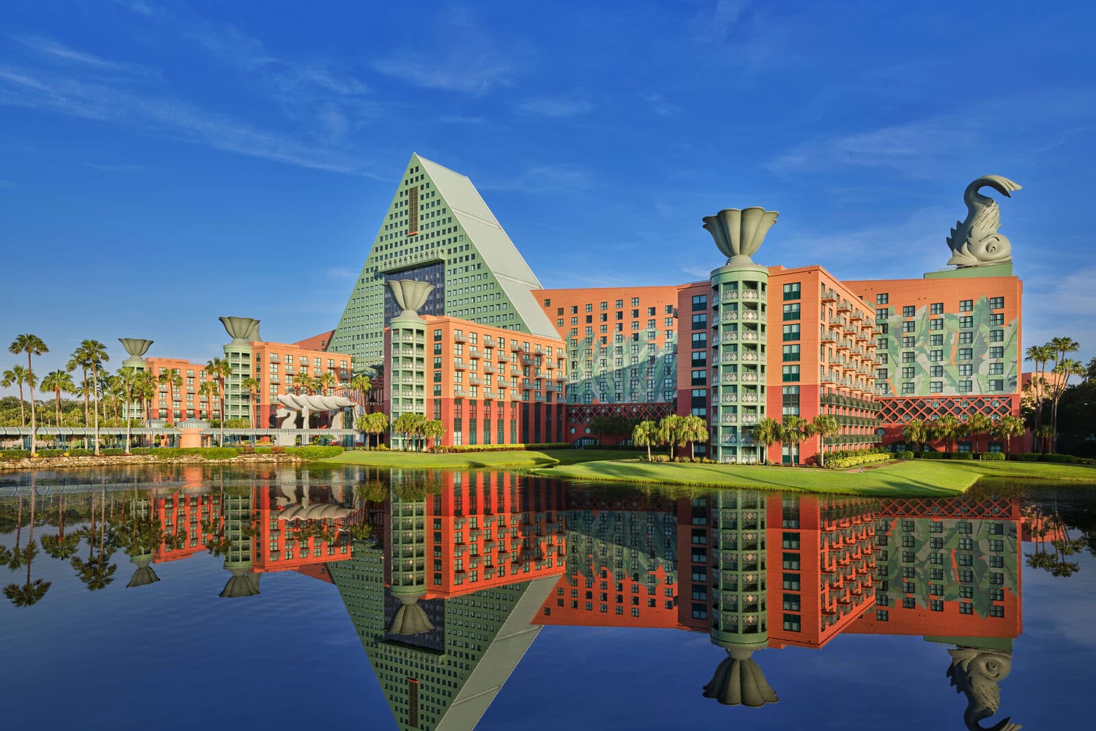 The Walt Disney World Dolphin's pyramid tower and dolphin statues reflected in the lake