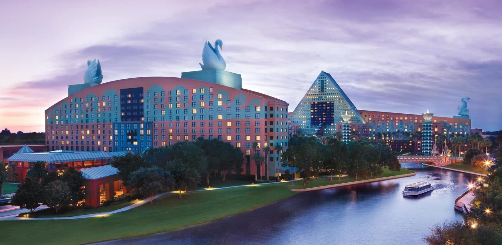 The Walt Disney World Swan at dusk beside the canal, with the Dolphin behind