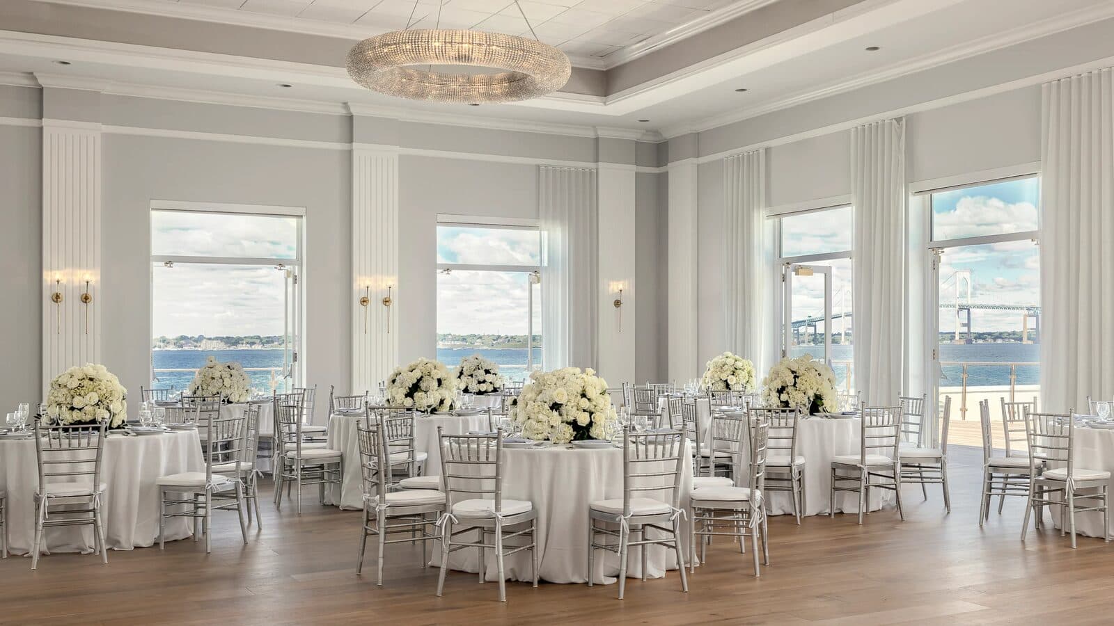 A waterfront ballroom at Newport Harbor Island Resort, with the Newport Bridge through tall windows