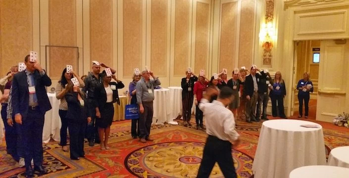 A group of people standing around in a room.
