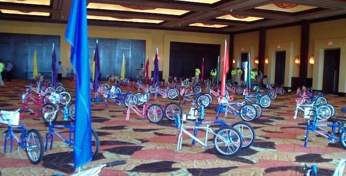 A room full of bicycles on a carpeted floor.