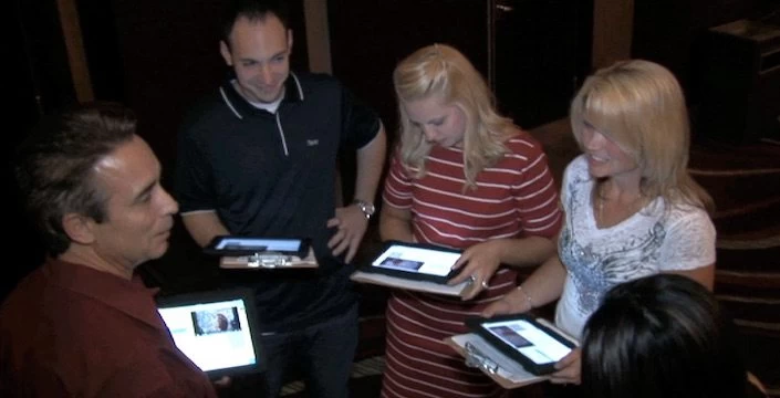 A group of people looking at a tablet computer.