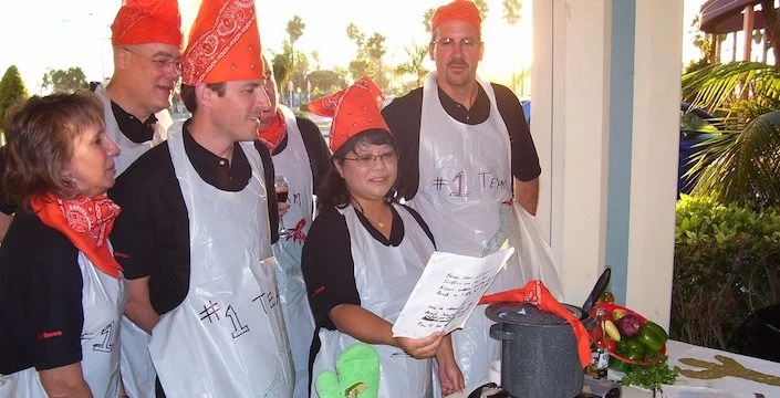 A group of people wearing aprons and hats.