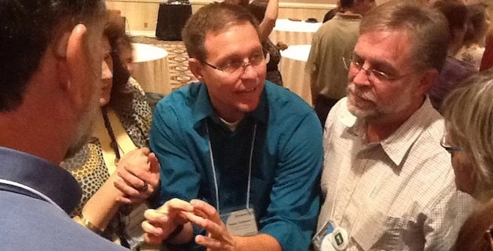 A group of people talking to each other at a conference.