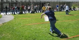 A group of people playing frisbee in a grassy area.