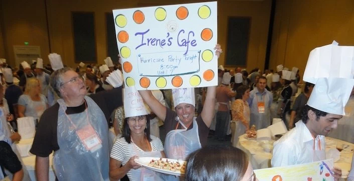 A group of people in aprons holding up a sign.