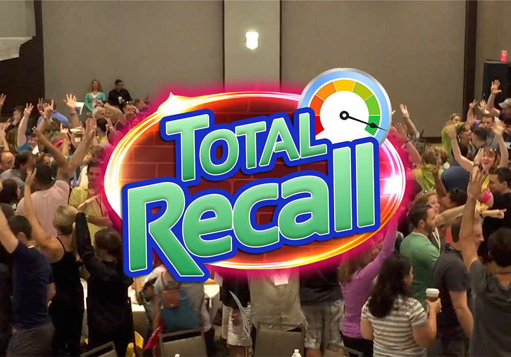 A large crowd of people raising their hands in a conference room, with a "Total Recall" graphic logo overlayed in the foreground.