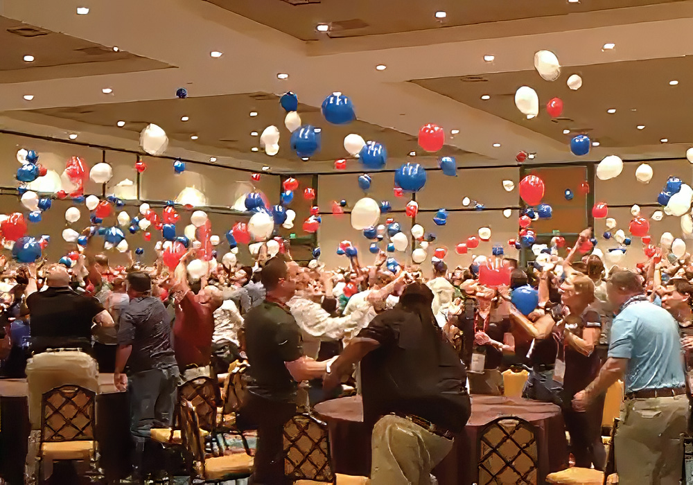A group of people in a room with balloons.