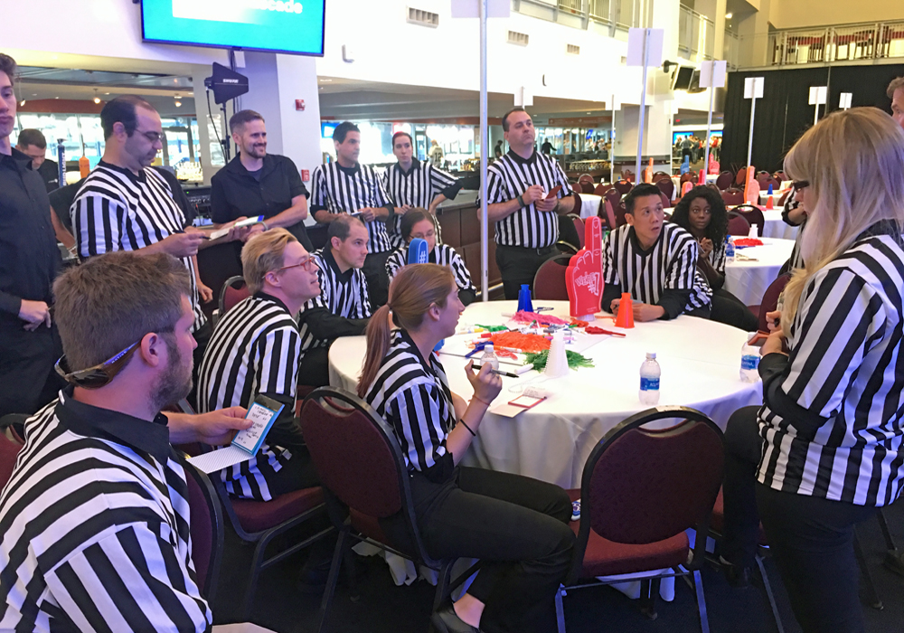 A group of referees sitting around a table.