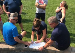 A group of people gathered around a piece of paper.