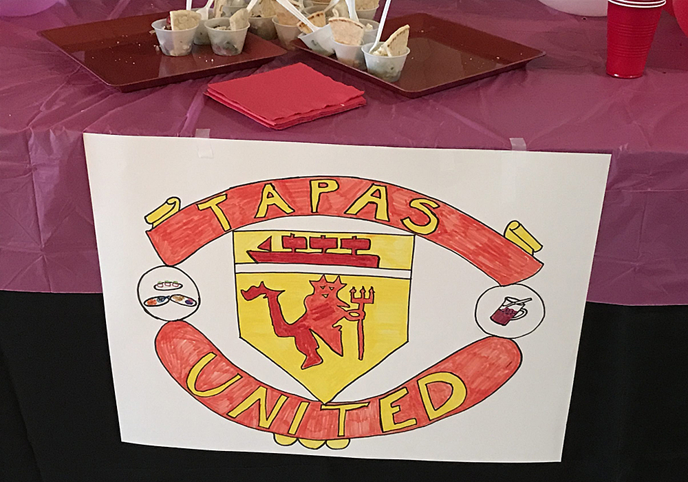 A table with a sign that says tapas united.