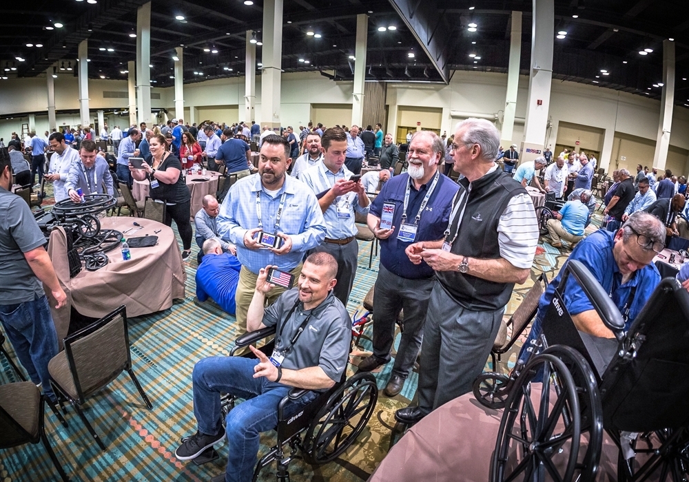 A group of people in wheelchairs at a convention.