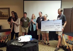 A group of people holding a check.