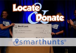 A group of people holding up a check with the words locate and donate.
