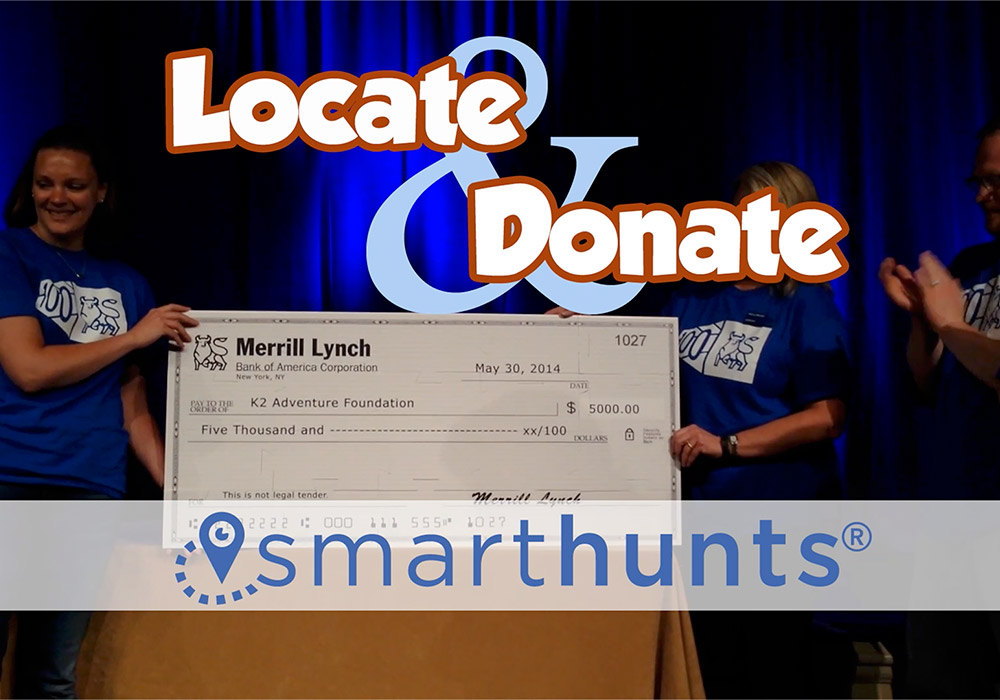 A group of people holding up a check with the words locate and donate.