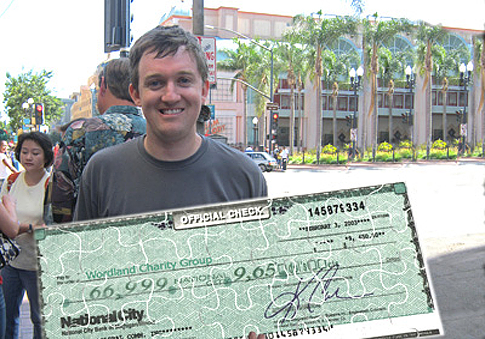 A man holding a check.