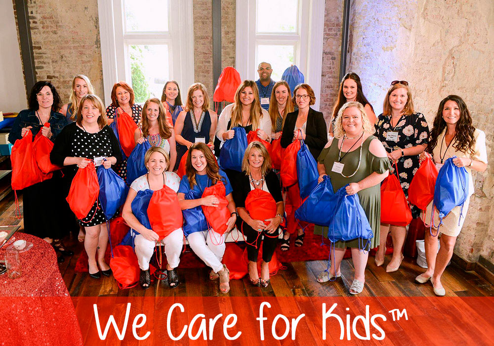 A group of people posing for a photo with the words we care for kids.