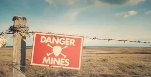 Danger mines sign on a barbed wire fence.