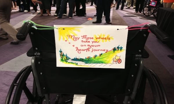 A wheelchair with a veterans sign on it.