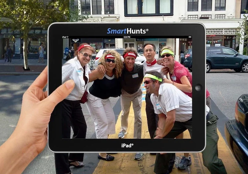 People posing for a picture on an ipad during a hunt.