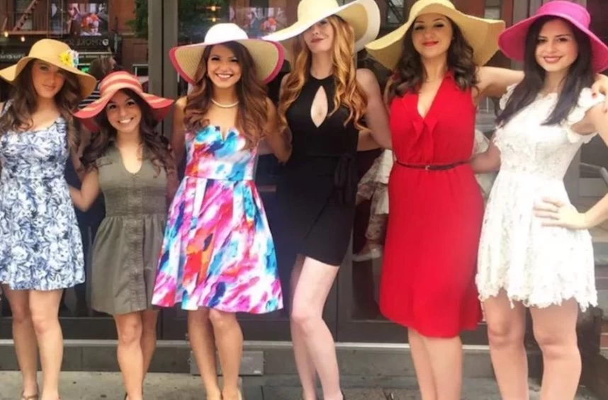 A group of women in hats posing for a picture.