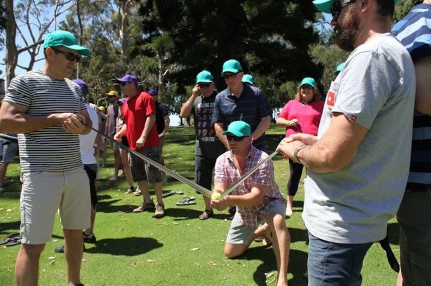 An outdoor team building activity taking place on a golf course.
