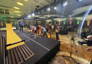 A group of people standing on a stage in a room.