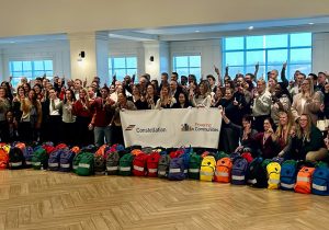 A group of people posing for a photo with backpacks.