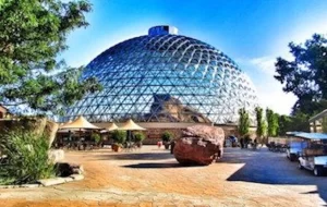 The zoo has a large dome in the middle of it.