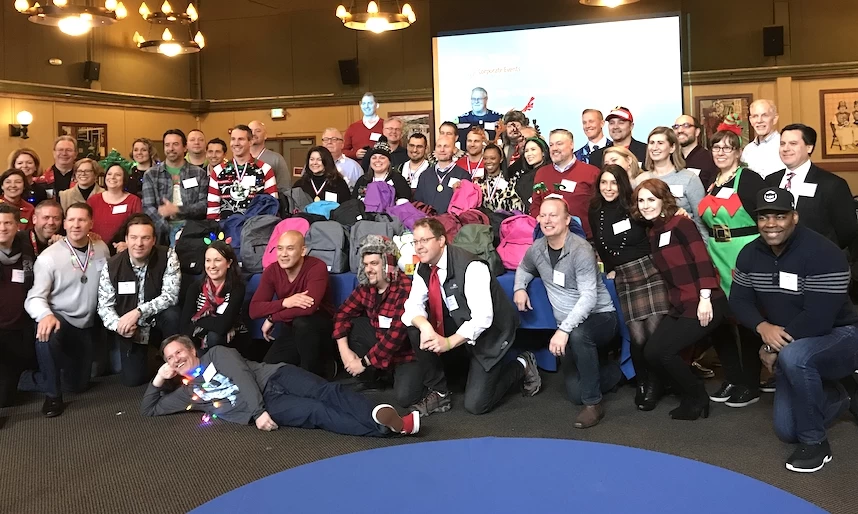 A group of people posing for a photo in a room.