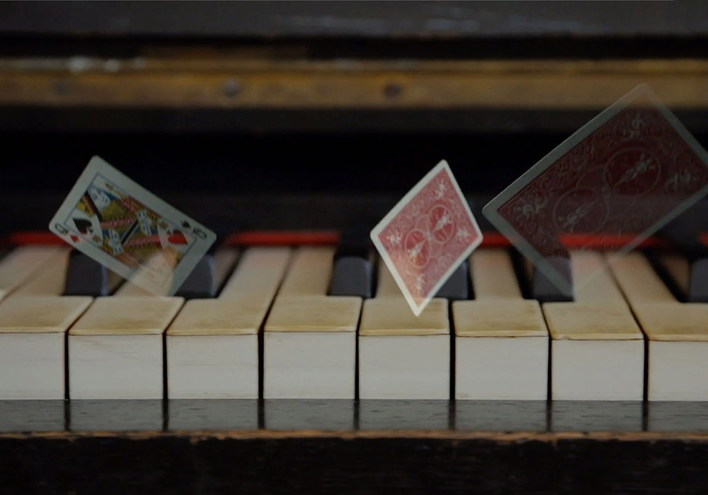 Playing cards on a piano.