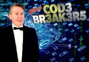A man in a tuxedo standing in front of a computer screen.
