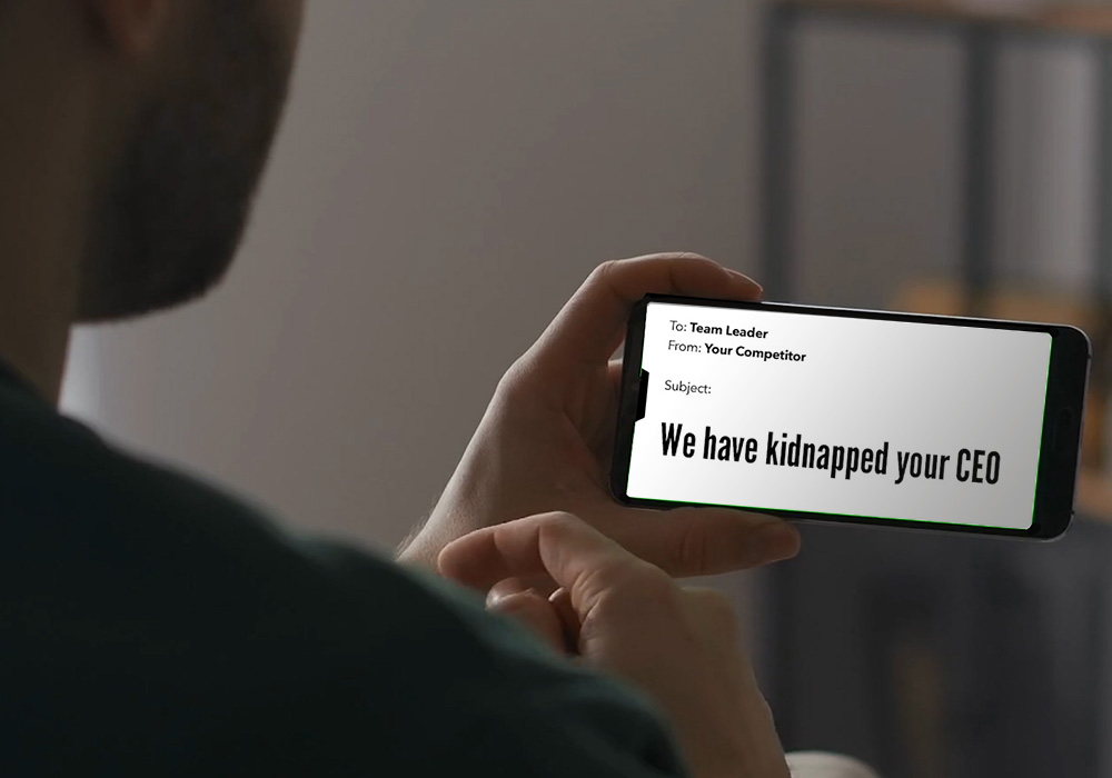 A man is holding up a smartphone with a message on it.