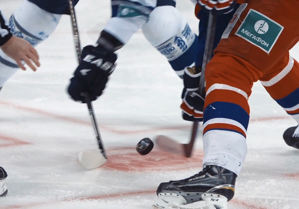 A hockey player is trying to score a goal.