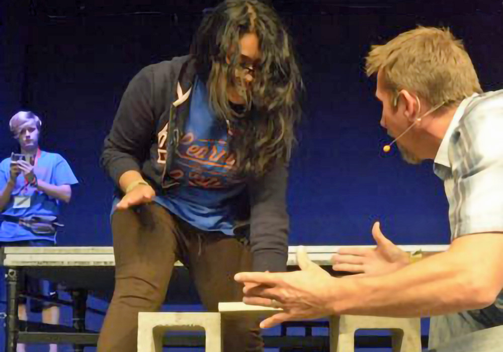 A man and a woman on stage playing a game of chess.